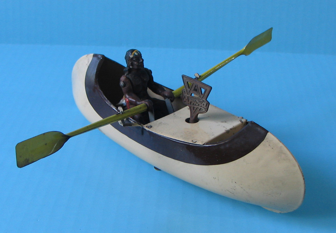 ​ARNOLD rowing canoe toy boat with indian figure. 